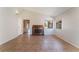 Bright living room featuring a brick fireplace and neutral tile flooring at 5453 Requa Ave, Las Vegas, NV 89110