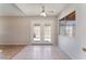 Bright living room with ceiling fan and glass french doors leading to the backyard at 5453 Requa Ave, Las Vegas, NV 89110