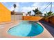 Kidney-shaped pool in backyard with orange house at 5453 Requa Ave, Las Vegas, NV 89110