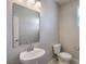 Clean bathroom with pedestal sink and toilet at 5520 Acadia Leaf St, Las Vegas, NV 89149