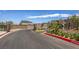 Gated entrance to Acacia Landing community with landscaped medians and curving driveway at 5520 Acadia Leaf St, Las Vegas, NV 89149