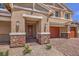 Front entrance with stone accents and a double door at 5520 Acadia Leaf St, Las Vegas, NV 89149