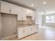 Small galley kitchen with white cabinets and granite countertops at 5520 Acadia Leaf St, Las Vegas, NV 89149