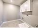 Bright laundry room with white cabinets and tile floor at 5520 Acadia Leaf St, Las Vegas, NV 89149