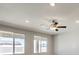 Bright living room featuring ceiling fan and large windows at 5520 Acadia Leaf St, Las Vegas, NV 89149