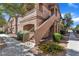 Tan two-story building with stairs and landscaping at 5751 E Hacienda Ave # 232, Las Vegas, NV 89122