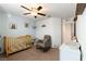 Bedroom with crib, rocking chair, and plenty of natural light at 5824 Petrified Tree Ln, North Las Vegas, NV 89081