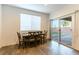 Breakfast nook with wooden table and sliding glass door to backyard at 5824 Petrified Tree Ln, North Las Vegas, NV 89081