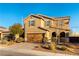 Two story house with brown exterior, wood garage door, and landscaping at 5824 Petrified Tree Ln, North Las Vegas, NV 89081