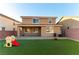 Two story house with backyard patio and grassy area at 5824 Petrified Tree Ln, North Las Vegas, NV 89081