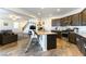 Modern kitchen with dark cabinets, granite counters and stainless steel appliances at 5824 Petrified Tree Ln, North Las Vegas, NV 89081