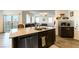 Kitchen island with granite countertop and double sink at 5824 Petrified Tree Ln, North Las Vegas, NV 89081