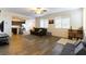 Open living room with hardwood floors, and a view into the kitchen at 5824 Petrified Tree Ln, North Las Vegas, NV 89081