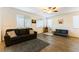 Living room with dark gray couch and wood-look tile floors at 5824 Petrified Tree Ln, North Las Vegas, NV 89081