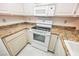 White appliances and granite countertops in this kitchen at 601 Cabrillo Cir # 323, Henderson, NV 89015