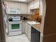 Updated kitchen with white appliances and light wood cabinets at 601 Cabrillo Cir # 323, Henderson, NV 89015