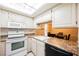 Bright kitchen features white appliances and ample cabinetry at 601 Cabrillo Cir # 323, Henderson, NV 89015