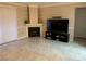 Living room with tiled floors, fireplace, and TV at 601 Cabrillo Cir # 323, Henderson, NV 89015