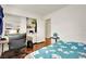 Bedroom with wood floors, a bed, and a home office setup at 6133 Meadowgrass Ln, Las Vegas, NV 89103