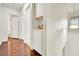 Clean hallway with wood floors and linen closet at 6133 Meadowgrass Ln, Las Vegas, NV 89103