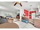 Bright kitchen with red cabinets, granite countertops, and modern appliances at 6133 Meadowgrass Ln, Las Vegas, NV 89103