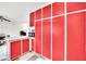 Red kitchen cabinets and an adjacent dining area at 6133 Meadowgrass Ln, Las Vegas, NV 89103