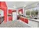 Modern kitchen with red cabinets and granite countertops at 6133 Meadowgrass Ln, Las Vegas, NV 89103