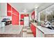 Kitchen features red cabinets, granite countertops, and a white refrigerator at 6133 Meadowgrass Ln, Las Vegas, NV 89103