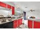 Eat-in kitchen with red cabinets and granite countertops at 6133 Meadowgrass Ln, Las Vegas, NV 89103