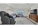 Living room with tiled floors and massage chair at 6133 Meadowgrass Ln, Las Vegas, NV 89103