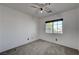 Bright bedroom featuring ceiling fan and neutral carpeting at 6285 Crusted Dome Ct, Las Vegas, NV 89139