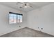 Bright bedroom with a window, ceiling fan and neutral carpet at 6285 Crusted Dome Ct, Las Vegas, NV 89139