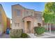 Beige two-story house with peach accents, two-car garage, and landscaping at 6285 Crusted Dome Ct, Las Vegas, NV 89139