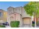 Tan two-story house with peach accents and a two-car garage at 6285 Crusted Dome Ct, Las Vegas, NV 89139