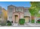 Two-story house with beige exterior, peach accents, and a two-car garage at 6285 Crusted Dome Ct, Las Vegas, NV 89139