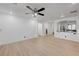 Open living room with wood-look floors and kitchen peek at 6285 Crusted Dome Ct, Las Vegas, NV 89139