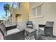 Relaxing patio area with wicker chairs and a glass-top table at 6285 Crusted Dome Ct, Las Vegas, NV 89139