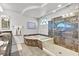 Luxurious bathroom featuring a soaking tub and walk-in shower at 6456 Grande River Ct, Las Vegas, NV 89139