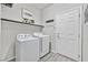 Bright laundry room with washer, dryer, and extra shelving at 6456 Grande River Ct, Las Vegas, NV 89139