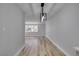 Bright dining room featuring wood-look floors and a window at 647 Greenbriar Townhouse Way, Las Vegas, NV 89121