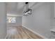 Dining area with wood-look floors and modern pendant lighting at 647 Greenbriar Townhouse Way, Las Vegas, NV 89121