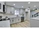 Modern kitchen featuring updated cabinetry, quartz countertops, and stainless steel appliances at 647 Greenbriar Townhouse Way, Las Vegas, NV 89121