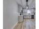 Modern kitchen featuring gray cabinets, quartz counters, and pendant lighting at 647 Greenbriar Townhouse Way, Las Vegas, NV 89121