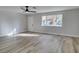 Living room with wood-look floors and ceiling fan at 647 Greenbriar Townhouse Way, Las Vegas, NV 89121