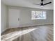 Living room featuring wood-look floors and lots of natural light at 647 Greenbriar Townhouse Way, Las Vegas, NV 89121