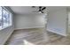 Living area with wood-look floors and a view to the kitchen at 647 Greenbriar Townhouse Way, Las Vegas, NV 89121