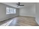 Living room with wood-look floors and large windows at 647 Greenbriar Townhouse Way, Las Vegas, NV 89121