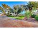 Landscaped backyard with a grassy area, trees, and a stone patio at 6640 Palmyra Ave, Las Vegas, NV 89146