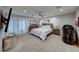 Main bedroom with a king-size bed and large TV at 6640 Palmyra Ave, Las Vegas, NV 89146