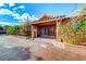 House entrance with decorative gate and landscaping at 6640 Palmyra Ave, Las Vegas, NV 89146